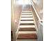 Staircase with wood-look treads and white risers at 779 Peregrine Falcon St, Henderson, NV 89015
