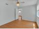 Bedroom featuring wood floors, ceiling fan, and an open doorway to another room at 7950 W Flamingo Rd # 1077, Las Vegas, NV 89147