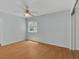 Bright bedroom featuring wood floors, ceiling fan, and a window with blinds at 7950 W Flamingo Rd # 1077, Las Vegas, NV 89147