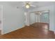 Bedroom featuring wood floors, ceiling fan, and mirrored closet doors with an attached bathroom at 7950 W Flamingo Rd # 1077, Las Vegas, NV 89147