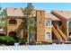 Charming condo showcasing classic architecture, stairs to the units, and well-maintained landscaping at 7950 W Flamingo Rd # 1077, Las Vegas, NV 89147