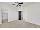 Bright bedroom featuring neutral carpet, a ceiling fan, and a black paneled door at 8043 Tank Loop St, Las Vegas, NV 89166