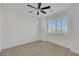 Bright bedroom featuring neutral carpet, rectangular window, and a ceiling fan at 8043 Tank Loop St, Las Vegas, NV 89166