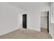 Bright bedroom featuring neutral carpet, paneled door, and an attached closet at 8043 Tank Loop St, Las Vegas, NV 89166
