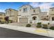 Inviting two-story home with a brick driveway, a two-car garage, and desert landscaping at 8043 Tank Loop St, Las Vegas, NV 89166