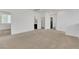 Large loft with carpet flooring leading to a bathroom with a black door at 8043 Tank Loop St, Las Vegas, NV 89166