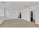 Expansive loft area featuring natural light, neutral carpet, and black paneled doors at 8043 Tank Loop St, Las Vegas, NV 89166