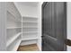 Bright walk-in closet with built-in shelving and a black paneled door at 8043 Tank Loop St, Las Vegas, NV 89166