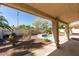 Backyard showcasing an inground jacuzzi, desert landscaping, and covered patio at 8105 Tropic Isle Cir, Las Vegas, NV 89128