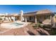 Backyard with a red tile roof with solar panels, inground jacuzzi and desert landscaping at 8105 Tropic Isle Cir, Las Vegas, NV 89128