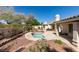 Backyard featuring an inground jacuzzi, desert landscaping, and a covered patio at 8105 Tropic Isle Cir, Las Vegas, NV 89128