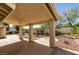 Covered patio with decorative pillars overlooking the backyard at 8105 Tropic Isle Cir, Las Vegas, NV 89128