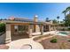 Backyard featuring an inground jacuzzi, covered patio with solar panels on a red tile roof at 8105 Tropic Isle Cir, Las Vegas, NV 89128