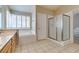 Bathroom showcasing a garden tub, glass enclosed shower, double sinks and natural light at 8105 Tropic Isle Cir, Las Vegas, NV 89128