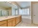 Bathroom with double sinks, garden tub, and bright natural light from plantation shutters at 8105 Tropic Isle Cir, Las Vegas, NV 89128