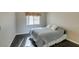 Cozy bedroom with wood floors, a bed with plush pillows and a window with curtains at 8105 Tropic Isle Cir, Las Vegas, NV 89128