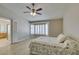 Bedroom featuring plank flooring, ceiling fan, and a bay window with access to the primary bathroom at 8105 Tropic Isle Cir, Las Vegas, NV 89128