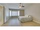 Bright bedroom featuring a ceiling fan, plank flooring, and a bay window with plantation shutters at 8105 Tropic Isle Cir, Las Vegas, NV 89128