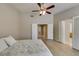 Bedroom features plank flooring, ceiling fan, and bright natural light with ensuite bathroom access at 8105 Tropic Isle Cir, Las Vegas, NV 89128