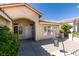 Entrance to home featuring a well-lit covered porch, desert landscaping, and secure screen door at 8105 Tropic Isle Cir, Las Vegas, NV 89128