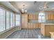 Bright kitchen with ample cabinet space, center island, and large window with plantation shutters at 8105 Tropic Isle Cir, Las Vegas, NV 89128