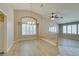 Bright living room featuring wood floors, plantation shutters, arched window and chandelier at 8105 Tropic Isle Cir, Las Vegas, NV 89128