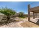 Picture perfect backyard with manicured lawn, desert landscaping, brick patio, and a cozy fire pit area at 8108 Artistic Heights Ct, Las Vegas, NV 89143
