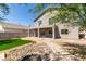 Backyard with upper and lower patios, grass lawn, privacy fence, and desert landscaping at 8108 Artistic Heights Ct, Las Vegas, NV 89143