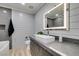 Modern bathroom with floating vanity, decorative mirrors, walk-in shower, and soaking tub at 8108 Artistic Heights Ct, Las Vegas, NV 89143
