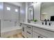 Modern bathroom featuring a double vanity, quartz countertops, and a separate soaking tub at 8108 Artistic Heights Ct, Las Vegas, NV 89143