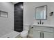 Modern bathroom features sleek black and white tile, a walk-in shower, and contemporary fixtures at 8108 Artistic Heights Ct, Las Vegas, NV 89143