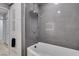Modern bathroom showcasing a sleek tiled shower and a luxurious soaking tub, alongside custom storage cabinets at 8108 Artistic Heights Ct, Las Vegas, NV 89143