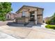 Two-story home with neutral stucco, a columned porch, and a two car garage at 8108 Artistic Heights Ct, Las Vegas, NV 89143