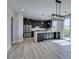 Modern kitchen design with gray cabinetry, stainless appliances, and island open to the living area at 8108 Artistic Heights Ct, Las Vegas, NV 89143