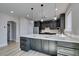 Elegant kitchen features stainless appliances, gray cabinets, and quartz counters at 8108 Artistic Heights Ct, Las Vegas, NV 89143