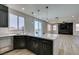 Beautiful kitchen boasts modern island, stainless dishwasher, sink and backyard patio views at 8108 Artistic Heights Ct, Las Vegas, NV 89143
