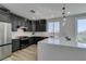 Gourmet kitchen with stainless appliances, gray cabinetry, large island, and ample counter space at 8108 Artistic Heights Ct, Las Vegas, NV 89143