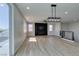 Bright and open living room with wood-look floors and modern lighting at 8108 Artistic Heights Ct, Las Vegas, NV 89143