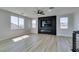 Bright open living space featuring modern fireplace and wood-look floors at 8108 Artistic Heights Ct, Las Vegas, NV 89143