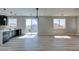 Bright open-concept space featuring light wood floors, slider to balcony, and modern lighting fixtures at 8108 Artistic Heights Ct, Las Vegas, NV 89143