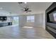 Bright and airy living room with wood flooring, sliding glass doors, and a modern fireplace feature at 8108 Artistic Heights Ct, Las Vegas, NV 89143