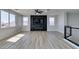 Upstairs living room with fireplace feature, wood floors, and large windows at 8108 Artistic Heights Ct, Las Vegas, NV 89143