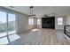 Open living space with wood-look floors, modern lighting, and cozy fireplace feature wall at 8108 Artistic Heights Ct, Las Vegas, NV 89143
