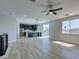 Open living area leading to modern kitchen with stainless steel appliances and island at 8108 Artistic Heights Ct, Las Vegas, NV 89143