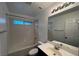 Bathroom with shower and tub, updated sink and vanity with plenty of light at 8218 Golden Flowers St, Las Vegas, NV 89139