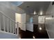 Bright entryway featuring wood floors, open floor plan, and stairs to the second level at 8218 Golden Flowers St, Las Vegas, NV 89139