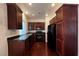 Modern kitchen boasts stainless steel appliances, dark wood cabinets, and black granite countertops at 8218 Golden Flowers St, Las Vegas, NV 89139