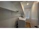 Convenient laundry area features a washer, dryer and shelving for supplies at 8218 Golden Flowers St, Las Vegas, NV 89139