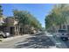 Tree-lined street showcasing the townhome-style homes and providing shade at 8218 Golden Flowers St, Las Vegas, NV 89139