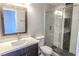 Modern bathroom featuring a vanity with stone countertop, and glass enclosed shower with decorative tile at 8600 W Charleston Blvd # 2068, Las Vegas, NV 89117